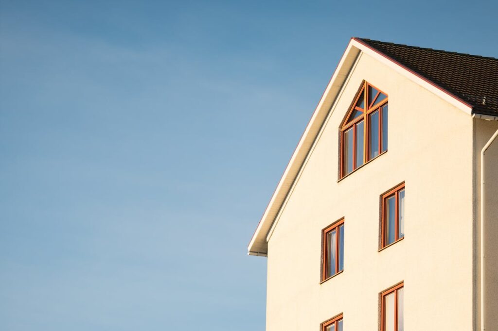 Crafting Captivating Headlines: Your awesome post title goes here Minimalist modern residential building facade against clear blue sky.